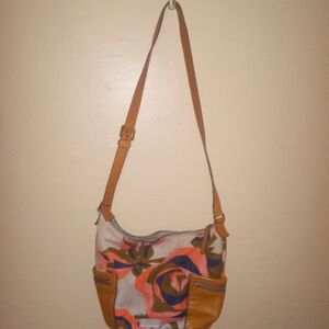Fossil shoulder strap purse has orange rose on it